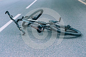 Bicycle lies on the pavement on the roadway. Concept on the theme of the accident