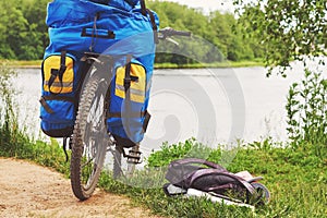 Bicycle with luggage stopped near the precipitous shore of river