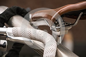 Bicycle luxury details. Parked Bicycles with Leather steering wheel at racing bike and Brown Leather bicycle saddle