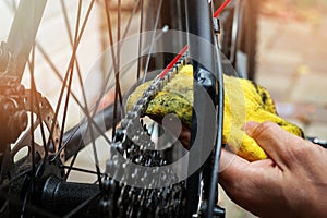 Bicycle maintenance and repair - cleaning and oiling mountain bike chain and gear with oil spray