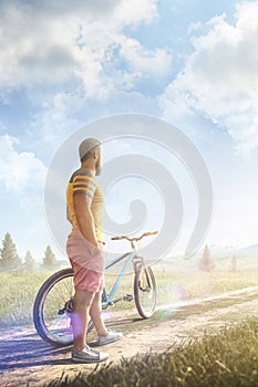 Bicycle. Man with bike on a forest road in the mountains at sunrise. Story