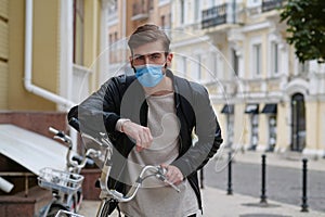 Bicycle man in medical protective mask and backpack