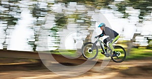 Bicycle, man and speed with motion blur in forest for sport, race or adventure in summer, woods or nature. Extreme fast