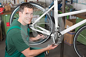 Bicycle mechanic repairing tooth belt in a workshop