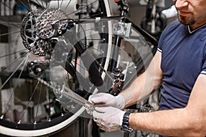 Bicycle mechanic in a workshop in the repair process