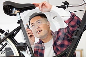 bicycle mechanic in workshop in repair process