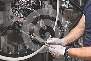 Bicycle mechanic in a workshop in the repair process