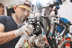 Bicycle mechanic in a workshop in the repair process