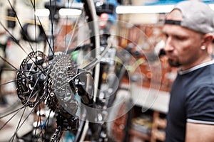 Bicycle mechanic in a workshop in the repair process