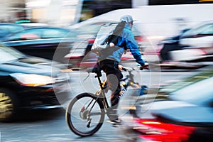 Bicycle messenger in busy city traffic