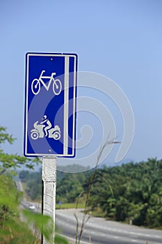 Bicycle and motorcycle signs on roadside