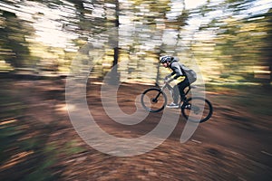 Bicycle, mountain bike and man cycling in the forest or woods fast, speed and adrenaline with motion blur. Extreme