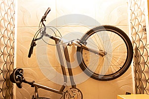 Bicycle mounted on the ceiling in a small residential apartment with limited space, bicycle storage at home