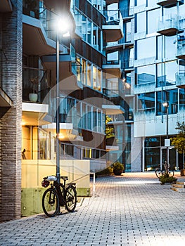 Bicycle near entrance to the modern apartment house in Oslo city district