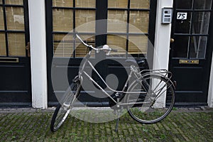 Bicycle near a typical building in Amsterdam. Amsterdam mode of transport