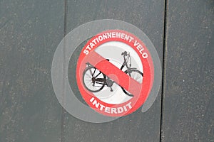 Bicycle no parking bike means in french stationnement velo interdit text and sign Do not park in front of residential gate photo