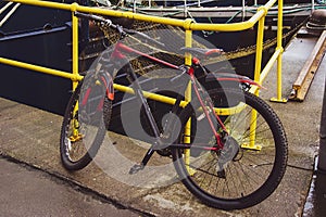 Bicycle padlocked to a yellow rail in Fraserburgh Harbour,Aberdeenshire, Scotland, UK.