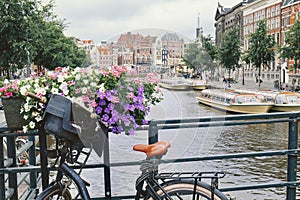 A bicycle parked on a bridge over one of the canals in Amsterdam, Holland