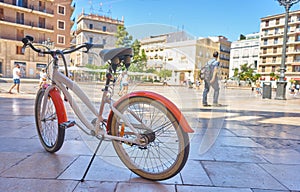 Bicycle parked on a city street. Cycling or commuting in the urban environment, ecological transport concept