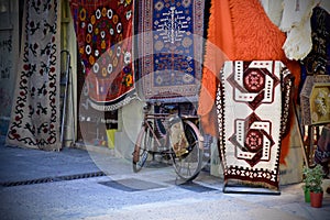 Bicycle parked in front of a rug store in Athens, Greece