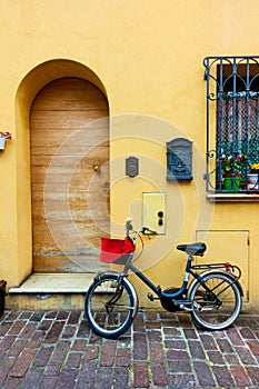 Bicycle parked next to door of old house