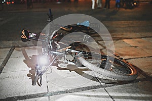 bicycle parked at night on a city street with a light lamp on