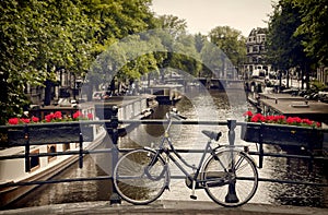 Bicycle Parked on the Pedestrian Bridge Overlooking a Canal in Amsterdam