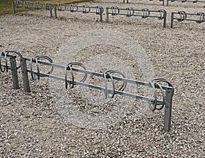 bicycle parking on a dirt area