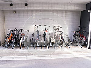 Bicycle parking roadside under building. One of many open bicycle parking spots in city streets