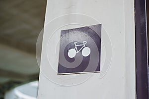 bicycle parking sign on the wall.