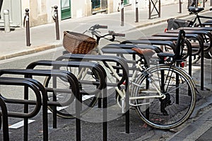 Bicycle parking in the street. Vintage bike with a  basket