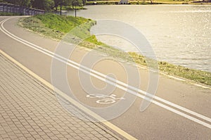 Bicycle path along the lake/bicycle path along the lake in sunrise