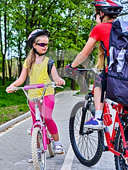 Bicycle path sign with children. Girls wearing helmet with rucksack .