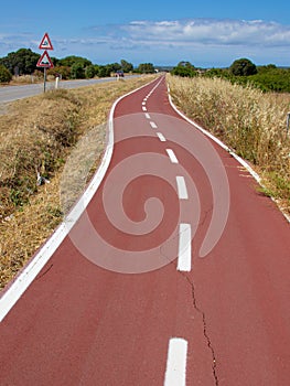 Bicycle path, two way cycling track with bicycle signs painted white photo