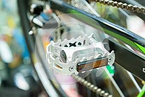 Bicycle pedal on a blurred bicycle background photo