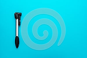 Bicycle pump over turquoise blue background with copy space