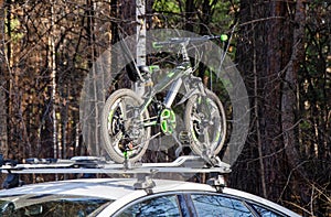 Bicycle rack with attached bicycle on roof of the car. car mounts, rails for transporting bicycles