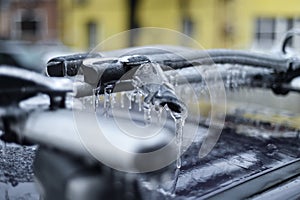 Bicycle rack on a car covered in ice after frozen rain