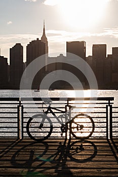 Bicycle on a Railing along the East River at Gantry Plaza State Park in Long Island City Queens during a Sunset with the Manhattan