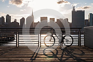 Bicycle on a Railing along the East River at Gantry Plaza State Park in Long Island City Queens during a Sunset with the Manhattan