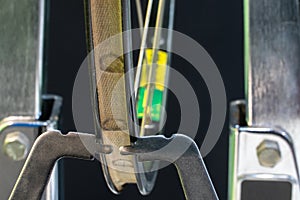 Bicycle repair. The front wheel is on a stand on a black background. Rim and spokes close-up. Mechanic levels the wheel in the