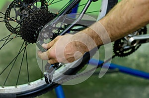 bicycle repair. mountain bike in the workshop. Rear derailleur adjustment