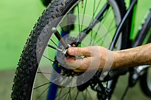 bicycle repair. mountain bike in the workshop. Rear derailleur adjustment