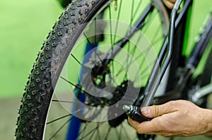 bicycle repair. mountain bike in the workshop. Rear derailleur adjustment