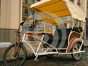 Bicycle rickshaw is parked on the street