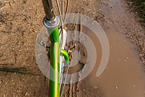 Bicycle ride through muddy dirt road