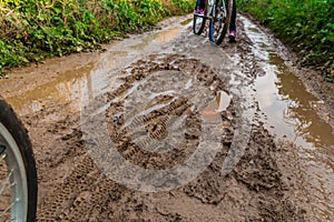Bicycle ride through muddy dirt road
