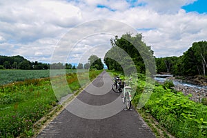 Bicycle ride in rural road in Biei, Hokkaido, Japan during bright summer day.