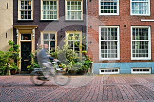 Bicycle rider cyclist man on bicycle very popular means of transoirt in Netherlands in street of Delft, Netherlands