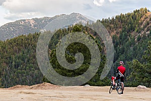 Bicycle rider and rocky mountain view